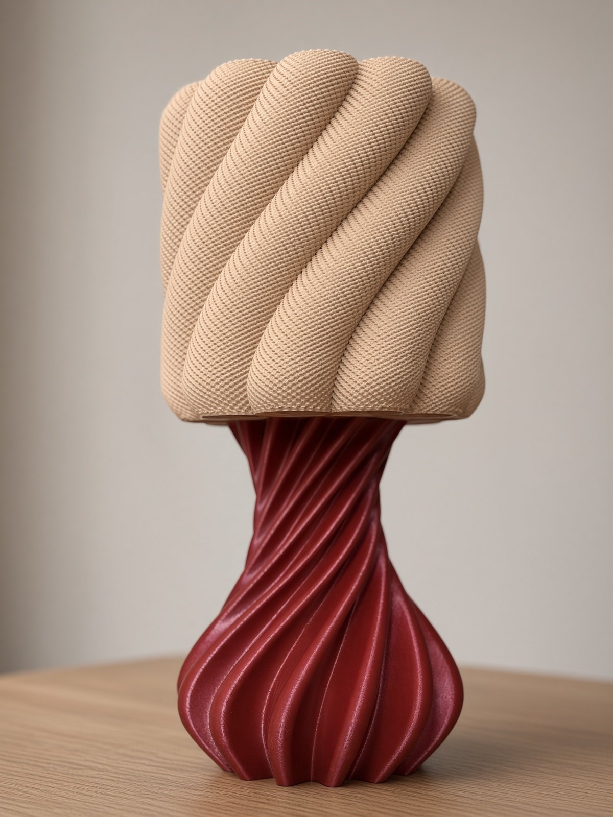 Aura lamp: a warm beige, twisting sculptural shade on a deep wine spiral base